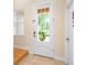 Bright foyer featuring a white door with a grid pattern, tile flooring, and natural light from the window at 11546 52Nd E Ct, Parrish, FL 34219