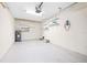 Spacious garage with painted concrete floors and walls, a water heater, and lots of shelving for storage at 11546 52Nd E Ct, Parrish, FL 34219