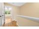 Upstairs hallway with wood floors leading to a bedroom at 11546 52Nd E Ct, Parrish, FL 34219