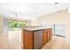 Bright kitchen featuring ceramic tile flooring and wooden cabinets with modern appliances at 11546 52Nd E Ct, Parrish, FL 34219