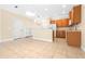 Bright kitchen featuring ceramic tile flooring and wooden cabinets with modern appliances at 11546 52Nd E Ct, Parrish, FL 34219