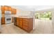 Bright kitchen featuring ceramic tile flooring and wooden cabinets with modern appliances at 11546 52Nd E Ct, Parrish, FL 34219