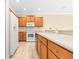 Bright kitchen featuring ceramic tile flooring and wooden cabinets with modern appliances at 11546 52Nd E Ct, Parrish, FL 34219