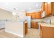 Bright kitchen featuring ceramic tile flooring and wooden cabinets with modern appliances at 11546 52Nd E Ct, Parrish, FL 34219