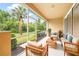 Outdoor patio featuring comfortable seating and peaceful views of the beautiful backyard with tropical plants at 11546 52Nd E Ct, Parrish, FL 34219
