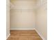 Empty walk-in closet with wood floors and multiple shelves for convenient storage and organization at 11546 52Nd E Ct, Parrish, FL 34219