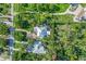 Aerial view of property showing lush landscaping and stylish turquoise accents on the exterior at 1217 N Florida Ave, Tarpon Springs, FL 34689