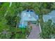 Aerial view of vibrant home and manicured yard. Features a rooftop pool at 1217 N Florida Ave, Tarpon Springs, FL 34689
