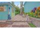 Whimsical backyard with brick pavers, landscaping, and fun dog statues at 1217 N Florida Ave, Tarpon Springs, FL 34689
