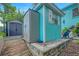 Backyard features storage shed with blue siding at 1217 N Florida Ave, Tarpon Springs, FL 34689