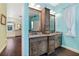 Bathroom featuring a double vanity, granite countertop, and an abundance of natural light at 1217 N Florida Ave, Tarpon Springs, FL 34689