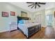 Bright bedroom with wooden floors, a ceiling fan, and art above the bed at 1217 N Florida Ave, Tarpon Springs, FL 34689