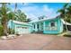 Attractive home boasting a brick driveway, a 2-car garage, and lush landscaping at 1217 N Florida Ave, Tarpon Springs, FL 34689