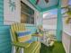 Charming front porch with comfortable seating, artificial turf, and decorative accents at 1217 N Florida Ave, Tarpon Springs, FL 34689