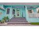 Inviting front porch featuring a vibrant color scheme and cozy seating area at 1217 N Florida Ave, Tarpon Springs, FL 34689
