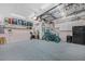 Large garage features painted floors, high ceilings with storage, and refrigerator at 1217 N Florida Ave, Tarpon Springs, FL 34689