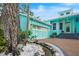 Beautiful home with a brick driveway, 2 car garage, and a rock water feature, complemented by lush landscaping at 1217 N Florida Ave, Tarpon Springs, FL 34689