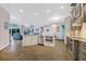 Open-concept kitchen with stainless steel appliances, granite countertops, and wood flooring at 1217 N Florida Ave, Tarpon Springs, FL 34689