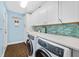 Updated laundry room features modern appliances, tile backsplash, and plenty of cabinets at 1217 N Florida Ave, Tarpon Springs, FL 34689
