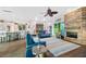 Open-concept living room and kitchen with a stone fireplace, wood floors, and bright light at 1217 N Florida Ave, Tarpon Springs, FL 34689