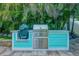 Well-equipped outdoor kitchen with built-in grill, stainless steel accents, and storage beneath at 1217 N Florida Ave, Tarpon Springs, FL 34689