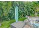 Unique outdoor shower installation with surfboard backing nestled amongst palm trees at 1217 N Florida Ave, Tarpon Springs, FL 34689