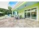 Inviting covered patio featuring tiled flooring, ceiling fans, ample seating, and sliding glass doors at 1217 N Florida Ave, Tarpon Springs, FL 34689