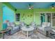Stylish covered patio with comfortable seating, ceiling fans, and colorful decorations at 1217 N Florida Ave, Tarpon Springs, FL 34689