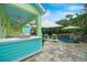 Outdoor pool area with bar, lounge chairs, waterfall features, and lush landscaping at 1217 N Florida Ave, Tarpon Springs, FL 34689
