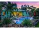 Inviting backyard pool with waterfall feature, surrounded by lush landscaping and a colorful home exterior at 1217 N Florida Ave, Tarpon Springs, FL 34689