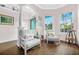 Cozy seating area with comfortable chairs, decorative pillows, and hardwood flooring at 1217 N Florida Ave, Tarpon Springs, FL 34689