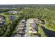 Aerial view of homes in a neighborhood with ponds and wooded areas, property marked with a red pin at 12593 Retreat Pl, Spring Hill, FL 34610