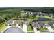 Scenic aerial view of a neighborhood featuring beautiful homes and tranquil ponds surrounded by lush greenery at 12593 Retreat Pl, Spring Hill, FL 34610