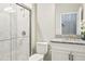 Bright bathroom with glass shower, granite countertop, and white cabinetry at 12593 Retreat Pl, Spring Hill, FL 34610