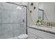Modern bathroom with a glass-enclosed shower, granite countertop, and stylish fixtures at 12593 Retreat Pl, Spring Hill, FL 34610