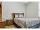 Comfortable bedroom with a decorative patterned bedspread, and coordinating wood furniture at 12593 Retreat Pl, Spring Hill, FL 34610