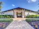 Inviting clubhouse entrance with well-maintained landscaping and a charming brick pathway at 12593 Retreat Pl, Spring Hill, FL 34610