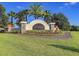 Landscaped entrance to the Talavera community featuring lush greenery and a decorative sign at 12593 Retreat Pl, Spring Hill, FL 34610