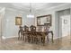 Formal dining room with wood floors and a large mirror reflecting natural light at 12593 Retreat Pl, Spring Hill, FL 34610