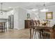 Elegant dining room featuring a wooden table, chandelier, and access to a modern kitchen at 12593 Retreat Pl, Spring Hill, FL 34610