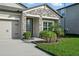 Charming home features a stone facade, well-manicured lawn, and inviting front entrance at 12593 Retreat Pl, Spring Hill, FL 34610