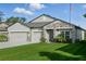 Charming single-Gathering home with a well-manicured lawn, a three-car garage, and stone accents at 12593 Retreat Pl, Spring Hill, FL 34610