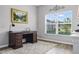 Cozy home office with a wooden desk, natural light, and a view of the outdoors at 12593 Retreat Pl, Spring Hill, FL 34610