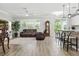 Open living room with a view of the kitchen bar and access to the outdoor patio at 12593 Retreat Pl, Spring Hill, FL 34610