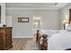 Spacious main bedroom with tray ceiling, with an en suite bath that is visible in background at 12593 Retreat Pl, Spring Hill, FL 34610