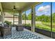 Relaxing screened patio with cozy seating, a fire pit, and serene pond views at 12593 Retreat Pl, Spring Hill, FL 34610