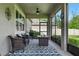 Enjoy outdoor relaxation on this screened patio with wicker furniture and cozy fire pit at 12593 Retreat Pl, Spring Hill, FL 34610
