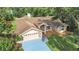 Overhead view of a home featuring a well-manicured lawn and a blue driveway at 13094 Huntington Woods Ave, Spring Hill, FL 34609
