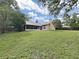 Spacious backyard featuring a screened porch and lush greenery, ideal for outdoor relaxation and enjoyment at 13094 Huntington Woods Ave, Spring Hill, FL 34609