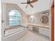 This bright bathroom offers a large soaking tub, a vanity with dual sinks and lots of natural light at 13094 Huntington Woods Ave, Spring Hill, FL 34609